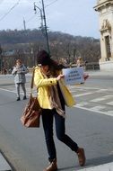 girl in a yellow jacket with an ad in Prague