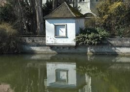 the house is reflected in the water