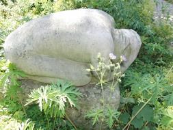 stone sculpture of an enslaved man
