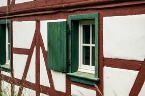 green shutters of a timber framed house