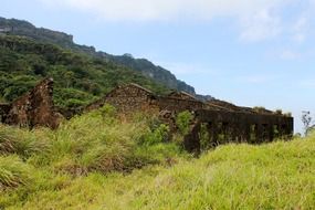 old ruined house on a green hill