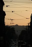 wires across street in city at evening sky