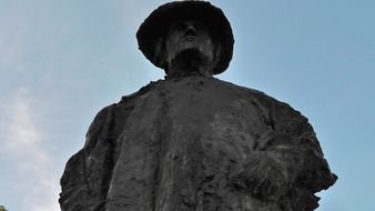 man in a hat iron monument