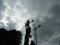 cranes on gray sky background