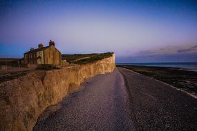 building on a cliff by the ocean