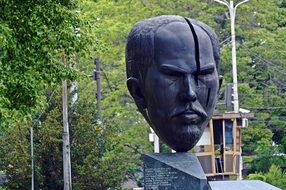 sculpture of a man's head in a city park