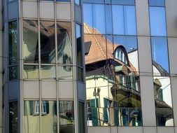 Mirroring of the houses in the glass building