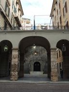 arch on the street between the buildings