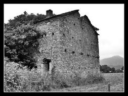 ruins of a stone house in a black frame