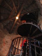 spiral staircase with iron railing in tower