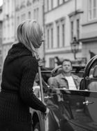 black white photo of a woman on a city street