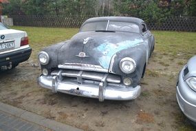 retro car is parked on the lawn