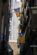 flags on a balconies on narrow street