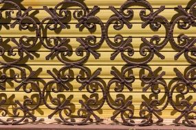 openwork metal grill and blinds as background