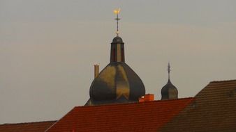 the dome of the cathedral on the background of red city roofs