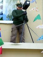 mannequin with a camera at a street festival