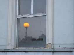 yellow ball is reflected in the window