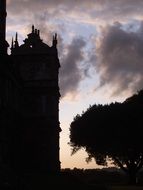 silhouette of the building on a background of clouds at sunset