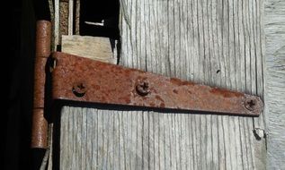 rusty hinge on a wooden door close up