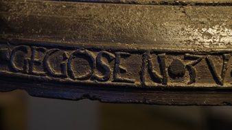 Inscription on an old alarm bell close-up