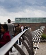 people walking on millennium bridge across thames river, uk, england, london