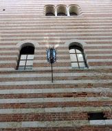 Facade of the building with a lamp post in Verona