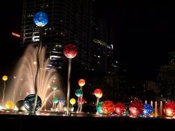 Multicolored bubbles on water at night City