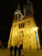 people near the cathedral at night