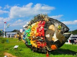 Monument in the form of a fish on the green grass