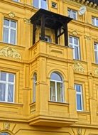 the yellow facade of the building