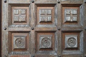carved flowers and cubes on an old door