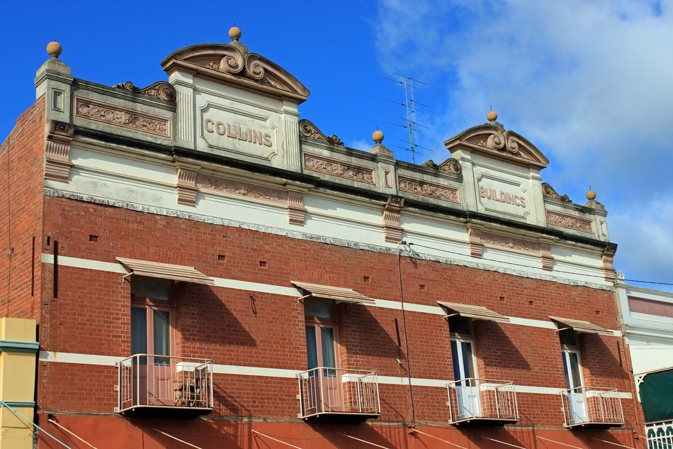 facade of a historic brick building with balconies