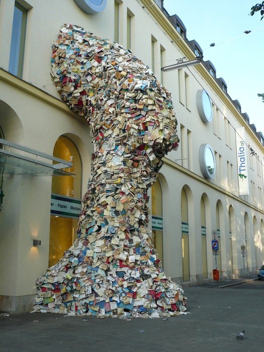 sculpture of books on the pedestrian street