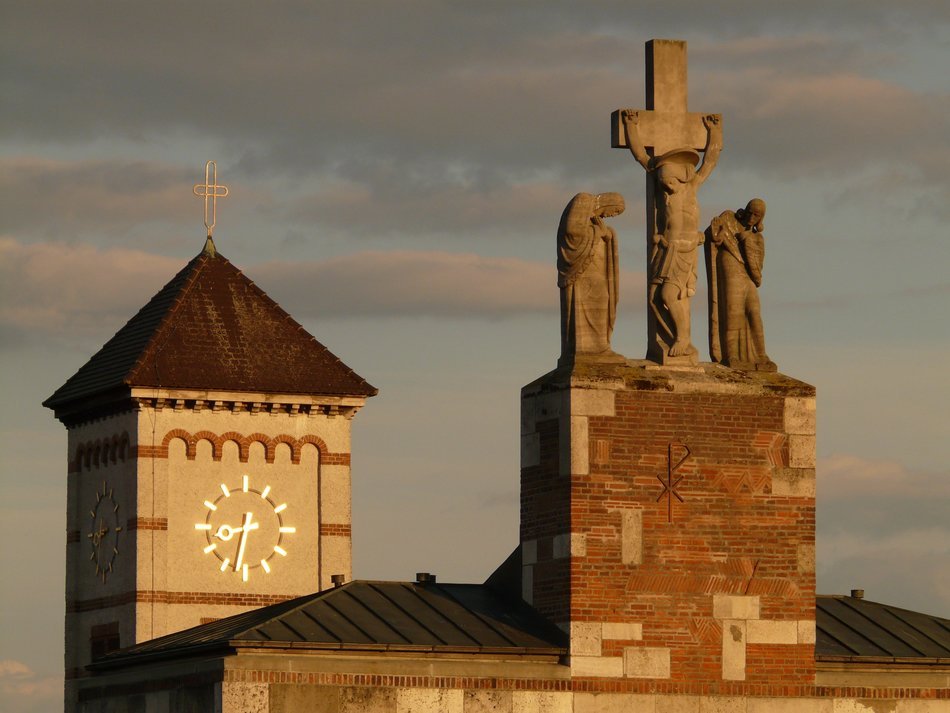 clock tower and statues in the background of a stormy sky