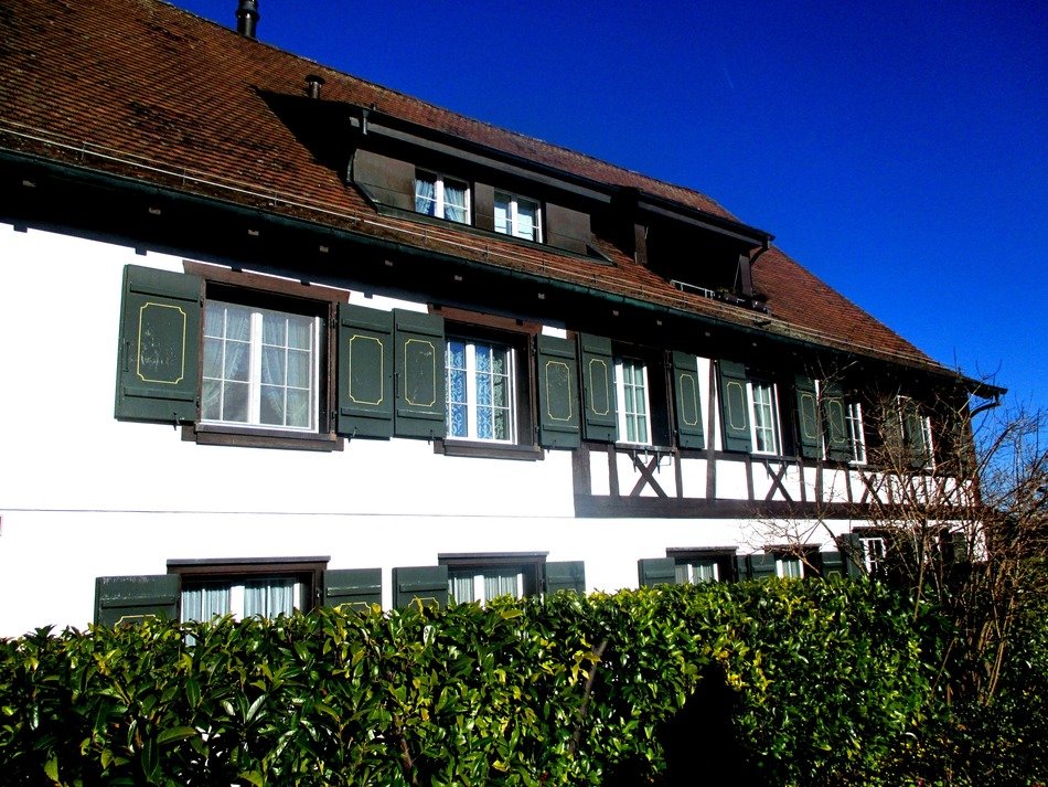 white house with brown roof