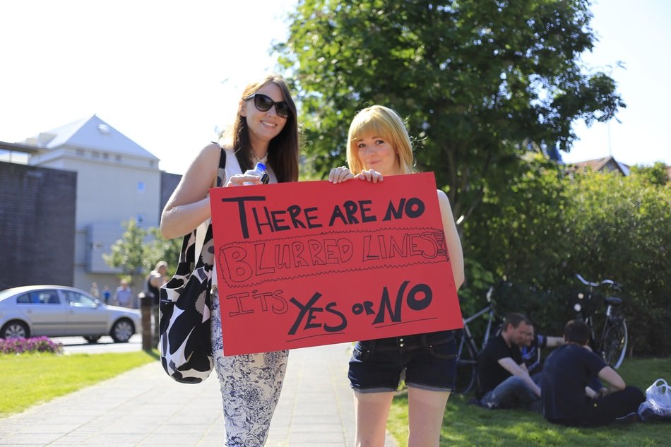 the two girls with sign in rejkjavik