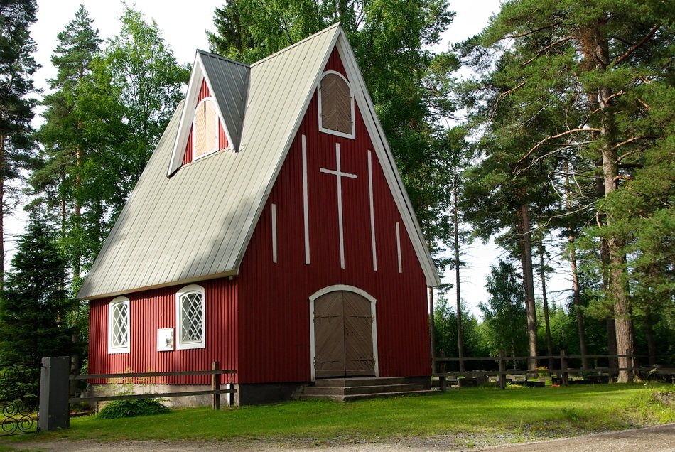 red wooden church in the finnish forest