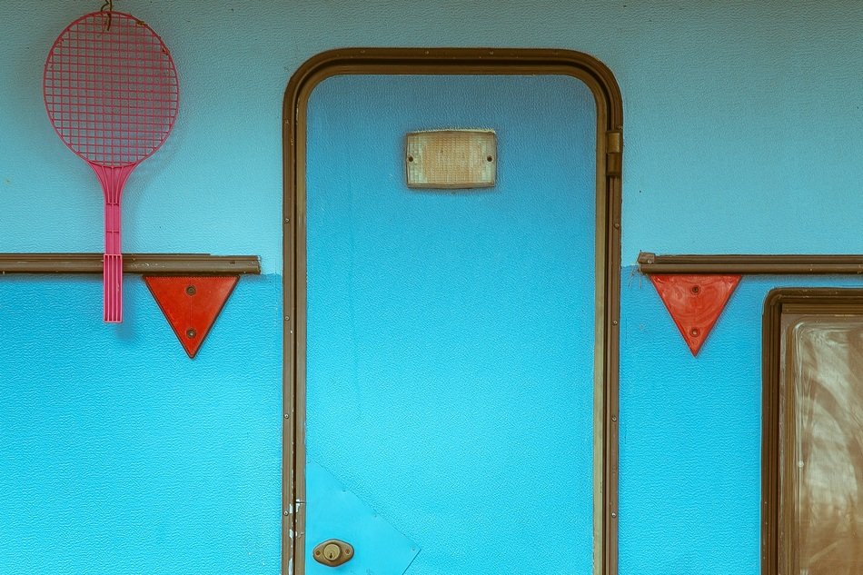 red racket at blue trailer door