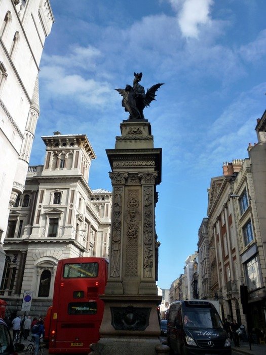 Monument and the red bus on Fleet Street in London