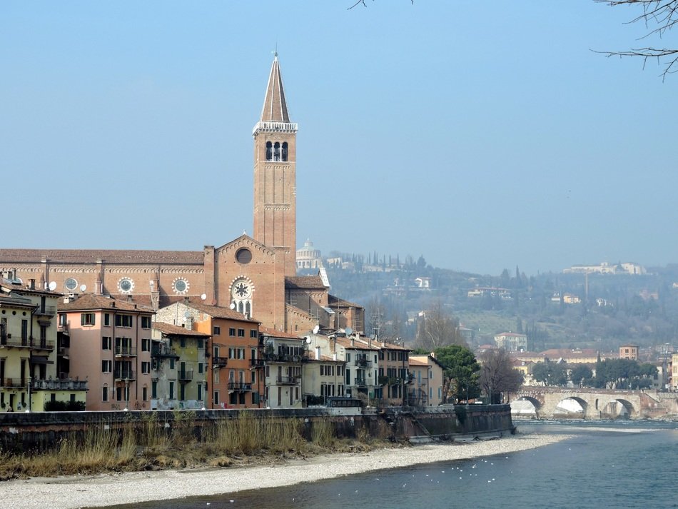 Church on the river bank in Italy