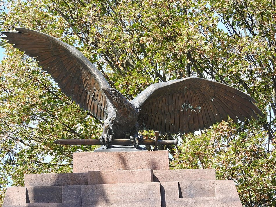 statue of a bird in the sun