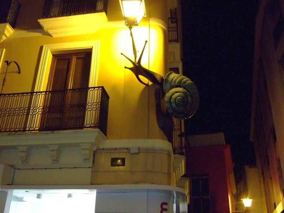 sculpture of the snail on a building, spain, andalusia