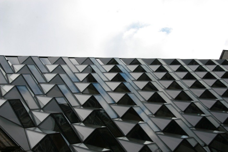 glass facade of a building with an abstract pattern