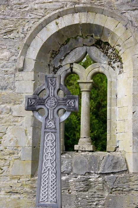 celtic cross near the arched window