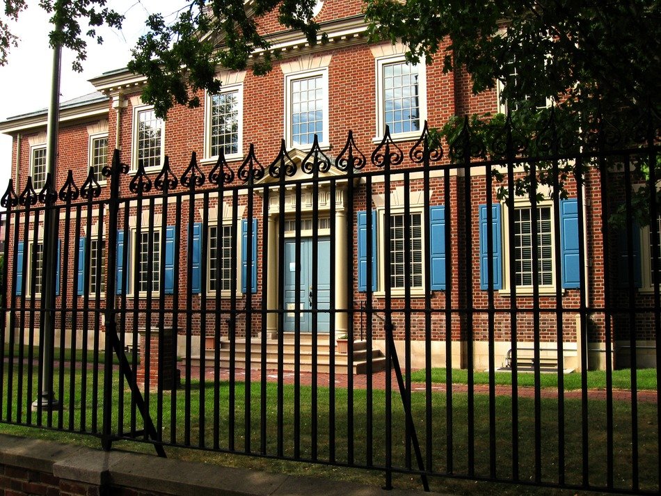 the building of their brick behind the fence