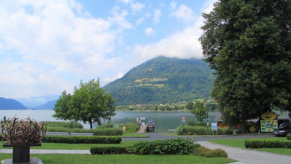park in front of water in coastal town at summer