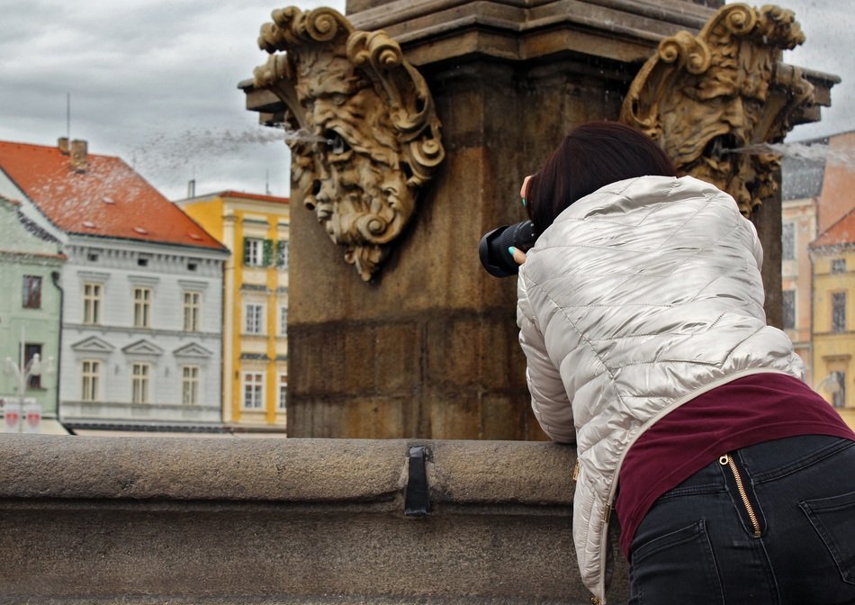 girl taking pictures of fountain, czech, budejovice