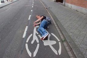 a man lies on a bike path