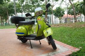 green scooter in the park near the house