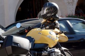 motorcyclist stands near a motorcycle